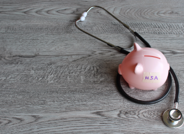 Piggy bank with stethoscope symbolizing health savings account for long-term care.”